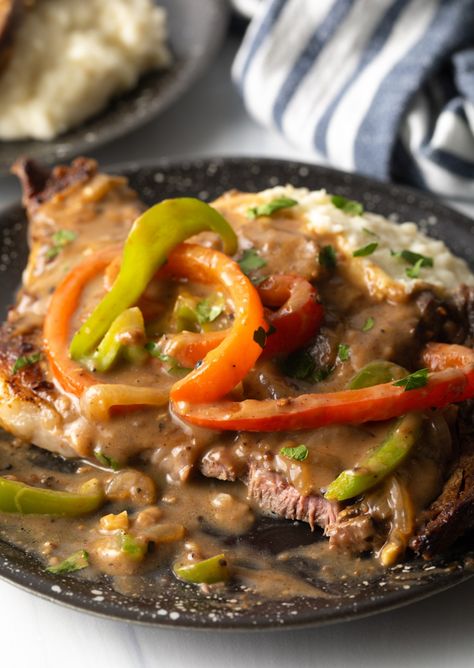 The BEST Smothered Steak and Onions with Gravy Recipe - Seared steak with onions, bell peppers, and a rich brown gravy is perfect to serve with low carb or starchy sides. This deliciously comforting dinner is ready in under 30 minutes! | A Spicy Perspective Beef Chuck Steak Recipes, Beef Chuck Steak, Chuck Steak Recipes, Steak With Onions, Meat Gravy, Smothered Steak, Beef Chuck Steaks, Brown Gravy Recipe, Stir Fry Recipes Healthy