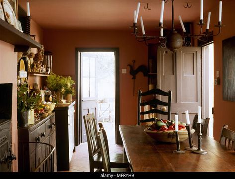 Country terracotta dining room wooden table chairs wrought iron chandelier Interiors rooms traditional period features furniture rustic oak Stock Photo Terracotta Walls Dining Room, Terra Cotta Dining Room, Terracotta Dining Room, Terracotta Walls, Wrought Iron Chandelier, South Street, Wooden Table And Chairs, Furniture Rustic, Iron Chandelier