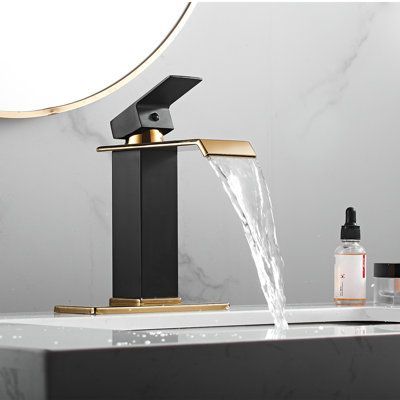 Wide-spread spout features dramatic waterfall effect. Solid brass die-cast to meet U.S. lead-free content standards, use with confidence. Precision machining to ensure long-lasting use without dripping. Finish: Black/Gold | YCCUZA Single Hole Faucet Single-handle Bathroom Faucet w / Drain Assembly in Yellow / Black | 7.11 H x 5.4 D in | Wayfair Gold Faucet Bathroom, Gold Bathroom Fixtures, Unique Bathroom Faucets, Black Faucet Bathroom, Matte Black Bathroom Faucet, Bathroom Faucets Black, Black Bathroom Faucet, Gold Bad, Compact Vanity