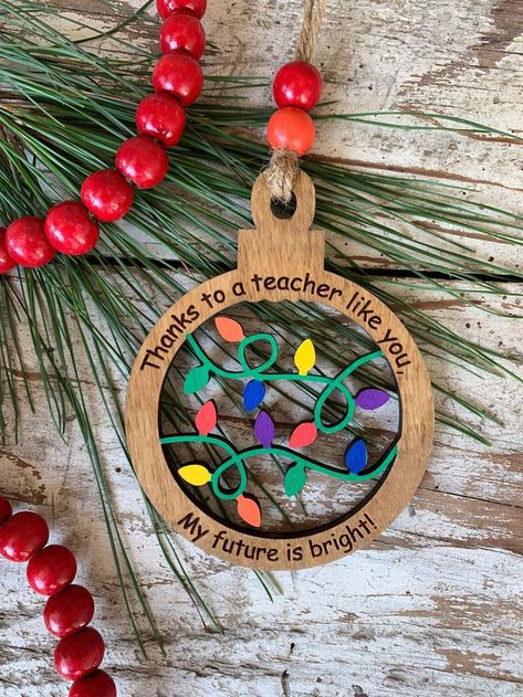 Celebrate your favorite teachers with unique Christmas ornaments. Explore ideas for personalized gifts, including engraved ornaments and DIY projects that show your appreciation. Best Teacher Ornament, Wooden Teacher Ornaments, Glowforge Ornament Ideas, Xtool M1 Project Ideas Christmas, Thank You Ornament, Diy Teacher Ornaments, Christmas Laser Projects, Wood Cut Ornaments, Teacher Ornaments Diy