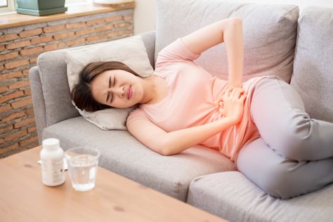 Woman clutching her abdomen in menstrual pain Thigh Cramps, Severe Menstrual Cramps, Bedtime Stretches, Lower Abdominal Pain, Period Pain Relief, Menstrual Period, Menstrual Pain, Obstetrics And Gynaecology, Period Pain