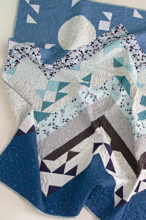 Bring the magic of winter into your home with our Wilderness Quilt, made with Arctic Tale Quilting fabrics. This playful patchwork quilt is a cozy addition to any space. Our premium Oeko-Tex cotton ensures vibrant colors and a soft feel. Grab your #AGFArcticTale fabrics and create your own handmade masterpiece! #WinterQuilt #PatchworkQuilt #QuiltingProject #Quilting #QuiltPatternFree #ThrowSizeQuilt #MountainQuilt #ModernFabric #ModernQuilting #WinterCrafts #WinterSewing Wilderness Quilt, Snowy Mountain Landscape, Quilt Pattern Free, Winter Sewing, Quilt Blocks Easy, Mountain Quilts, Diy Fabric Crafts, Start Quilting, Plaid Quilt