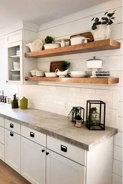 Bright White Kitchen with Concrete Countertops Concrete Countertops Kitchen Ideas, Kitchen Ideas Concrete Countertops, Grey Concrete Countertops Kitchen Ideas, White Kitchen And Grey Countertops, Simple Kitchen No Upper Cabinets, Shelves For Cabinets In Kitchen, Concrete Countertop Backsplash, White Kitchen Cabinets With Concrete Countertops, Open Shelving Next To Cabinets