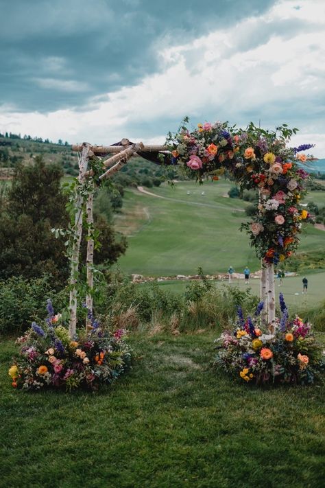 How to Style a Wedding With Colorful Flowers Wooden Flower Arch Wedding, Wedding Arch Flowers Colorful, How To Make Flower Arch Wedding, Colourful Flower Arch Wedding, Wedding In A Field Of Flowers, Decorated Wedding Arches, Wild Flower Arch Wedding, Wedding Pergola Flowers, Wedding Flower Arch Outdoor