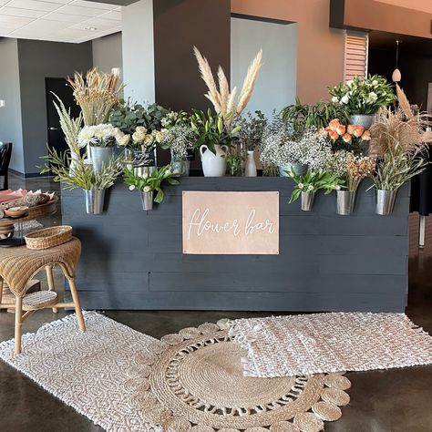 Flower bar, leather sign, Trader Joe’s flowers, women’s event Boho Flower Bar Ideas, Fall Flower Bar Ideas, Stem Bar Flower, Boho Flower Shop, Women's Conference Decor, Flower Booth Design, Flower Vendor Booth, Diy Flower Bouquet Bar, Flower Bar Baby Shower Ideas