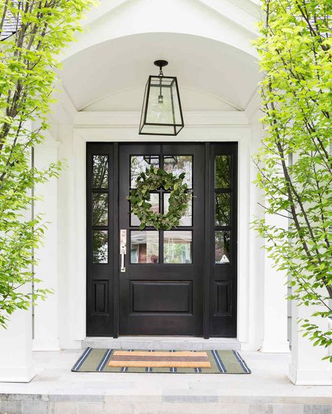 Ready to get inspired? Click through to see what our experts recommend you do right now if you're looking to boost your home's curb appeal. And if you're seeking more ways to amp up your home's exteriors, check out these beautiful landscaping ideas, plus festive ways to deck out your front porch this summer. #marthastewart #decorideas #diydecor French Door Porch, Colonial Front Door With Sidelights, Front Door On White House, Mcgee Exterior, Front Entryway Ideas Exterior, Exterior Front Door Ideas, Exterior Entryway Ideas, Front Door Ideas, Front Door Inspiration