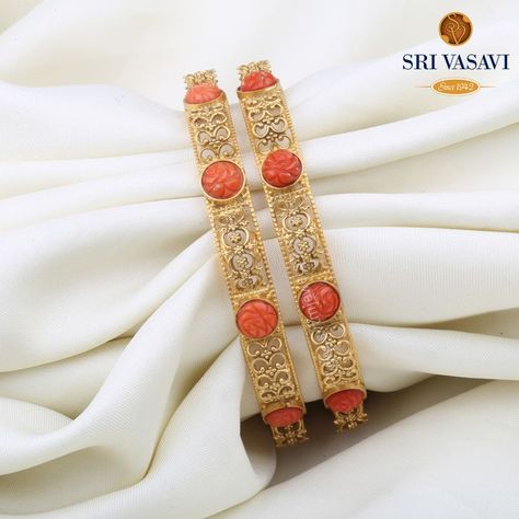 A stunning Pair of Bangles in coral topped by a pretty clasp. Wear this mesmerizing pair of 22kt gold bangles studded with coral stones and watch everyone go speechless with admiration. Coral Bangles, Delicate Gold Jewelry, Bangles Design, Bangles Jewelry Designs, Gold Bangles Design, Coral Stone, Coral Jewelry, Bangle Designs, Latest Jewellery