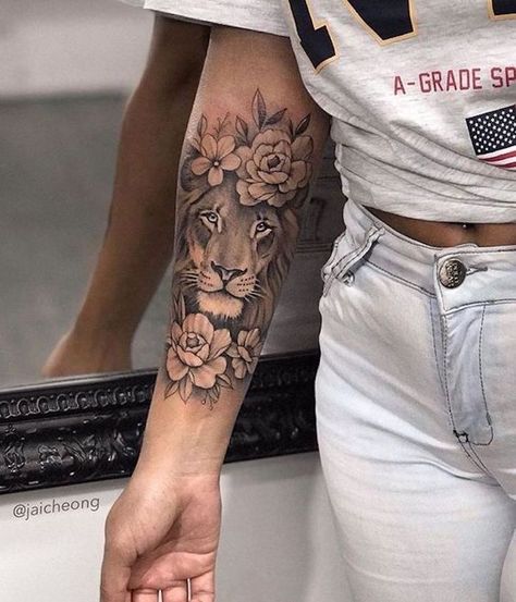 woman-wearing-white-jeans-grey-shirt-lion-tattoo-on-arm-forearm-tattoo-of-lion-head-surrounded-by-flowers Womens Tattoos Arm, Girl Arm Tattoos, Cool Arm Tattoos, Leo Tattoos, Inspiration Tattoos, Forearm Tattoo Women, Best Sleeve Tattoos, Arm Tattoos For Women, Arm Tattoos