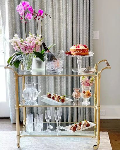 Make your bar cart stand out while entertaining or taking a break with florals, dinnerware, and some of your favorite pieces. We've 16 gorgeous bar ideas for you to see. Glam Coffee Bar, Glam Bar Cart, Bar Cart Ideas, Dining Table Guide, Snack Cart, Wine Cart, Gold Bar Cart, Cart Ideas, Tea Cart