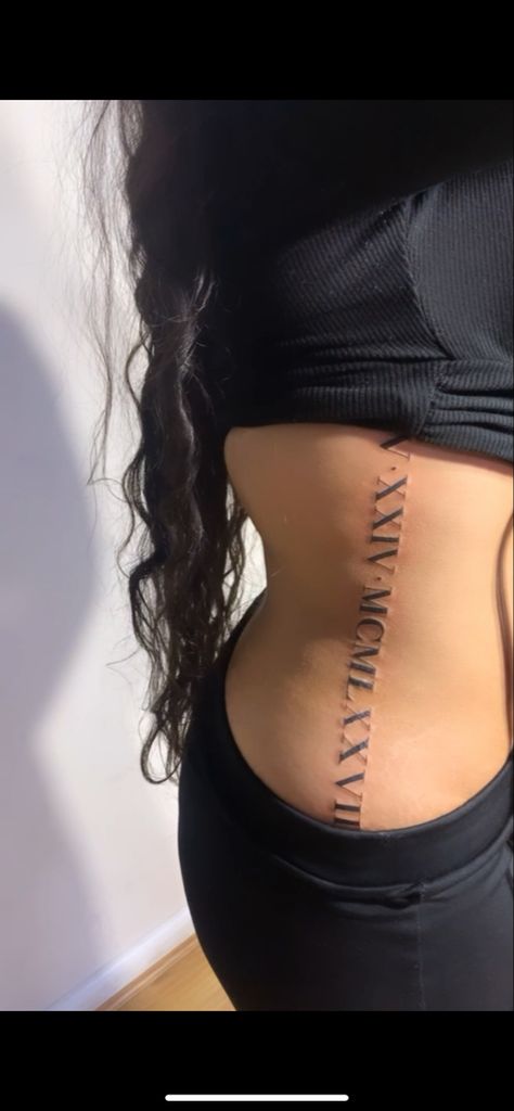 Roman Numeral Side Rib Tattoo, Rib Cage Tattoos Roman Numerals, Roman Numbers Tattoo Women Rib, Rib Tattoo Roman Numeral, Side Tattoos For Women Rib, Names On Ribs Tattoo, Tattoos Side Rib, Roman Numeral Tattoo On Neck, Roman Numeral Tattoo Placement Women