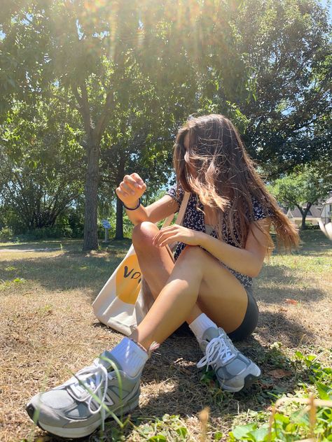 Girl wearing sneakers sitting in grass. Vogue tote bag, bike shorts, and long hair 2002 New Balance Outfit, Outfits To Wear With New Balance 990, Bew Balance Outfits, Outfits With New Balance Shoes 2002, New Balance 990v3 Outside Clothes, New Balance 990 Outfit, New Balance 990 V5 Outfit, New Balance 990 V5, Casual Summer Fits