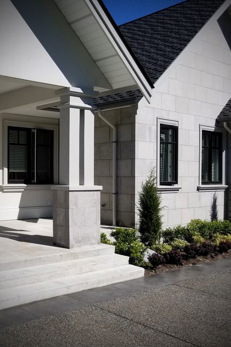 Modern front porch entrance exterior stone panel full width veneer stone house architecture design w/ stucco stone siding shows natural stone veneer masonry install for real stone home facade w/ entry pillar columns. Mortar masonry joint vs dry stacked stone install used. DIY https://www.buechelstone.com/masonry/ how to install stone veneer. Buy stone veneer natural stone cut Buechel Stone! #StonePanels #StoneVeneer #StoneHome #ModernHouse #ExteriorStoneVeneer #Masonry #HouseDesign #Stucco House Columns Exterior, House Pillars Columns Exterior, Modern Column Design Exterior, House Pillars Exterior, Pillar Design Exterior Entrance, Modern Pillar Design, Stone House Architecture, Exterior Pillars, Modern Columns