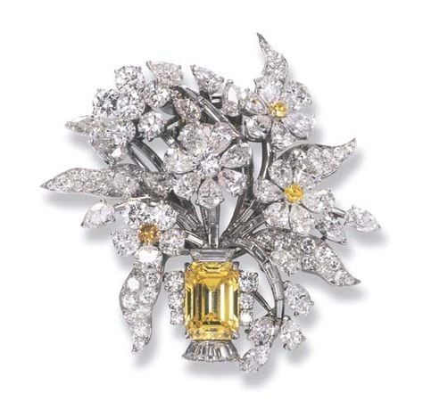 A COLOURED DIAMOND AND DIAMOND FLORAL BROOCH, BY BULGARI   The rectangular-cut fancy intense yellow diamond weighing 3.82 carats to the diamond floral bouquet with yellow diamond detail, mounted in platinum, circa 1960, 4.2 cm. high, with beige Bulgari pouch  Signed Bulgari Diamond Flower Brooch, Bijoux Art Nouveau, Leaf Brooch, Flower Leaf, Diamond Brooch, Diamond Flower, Fabulous Jewelry, Yellow Flower, Yellow Diamond