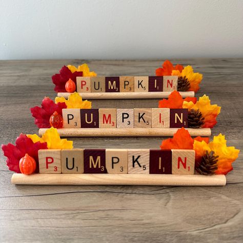 Vintage "PUMPKIN" Scrabble Letter Word Tile Holder with Embellishments, Fall and Halloween Decoration, Seasonal Home Decor, Gift These fun fall decorations are made repurposed vintage Scrabble game tiles spelling "PUMPKIN." They are upcycled and embellished with colorful faux fall leaves and plastic Jack-o'-lanterns and pinecones. These would make a great addition to any Halloween or Fall decor. This listing is for one (1) "PUMPKIN" Scrabble tile holder with embellishments. Please select the desired version using the drop down. Each finished decoration is approximately 8" long by 1.5" high and 1" deep. Please note: Due to the nature and age of the Scrabble letter tiles and holders, there may be minor scratches, discoloration, chips, or imperfections.   Please see photographs for detail.  C Diy With Scrabble Tiles, Fall Shelf Decor Ideas, Pumpkins Crafts, Fall Shelf Decor, Scrabble Tile Crafts, Fun Diy Halloween Decorations, Fall Diys, Scrabble Crafts, Clip Boards