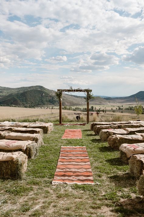 Steamboat Springs wedding photographer, La Joya Dulce wedding, Colorado ranch wedding venues, ceremony site with mountain views, wedding ceremony with hay bales, ceremony aisle with rugs Hay Seats For Wedding, Rustic Outdoor Wedding Ceremony Country Hay Bale Seating, Wedding Ceremony Hay Bales, Hay Bale Isle Wedding, Hey Bales Wedding, Cotton Field Wedding, Hay Bale Seating Wedding Ceremony, Hay Bale Wedding Ceremony, Hay Field Wedding Ceremony