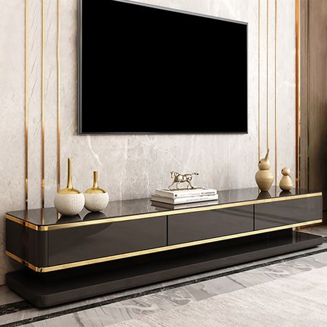 The black or white lacquer pairs perfectly with gold finish to add a modern and luxurious look. It features 3 drawers of solid wood to keep electronics, books, and media accessories tucked away neatly. Crafted from MDF, tempered glass, and stainless steel, it is built tough and made for long-term usage. Tv Cabinet Design Modern, Modern Tv Room, Modern Tv Unit Designs, Tv Fal, Tv Unit Design Modern, Wall Unit Designs, Tv Unit Decor, Modern Tv Wall Units, Tv Cabinet Design