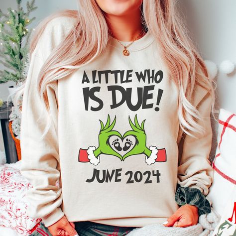 "🎄Celebrate the joy of pregnancy this holiday season with our \"A little Who is Due\" Christmas Sweatshirt! This cozy winter sweater is perfect for holiday gender reveals or as a thoughtful gift for expectant mothers at Christmas baby showers. Made with comfort in mind, it's a festive way to share your exciting news. Order now and make your holiday season extra special! 👕 PRODUCT INFO This unisex heavy blend crewneck sweatshirt and hoodie are pure comfort. These garments are made from polyester and cotton and run true to size with a loose fit. This combination helps designs come out looking fresh and beautiful. ✏️ DESIGN Designs are printed onto the shirt using Direct to Garment (DTG), which means the ink is laid directly into the fabric resulting in a bright, full-colored design. This h Telling Sister Your Pregnant Ideas, Grinch Baby Shower Ideas, Pregnancy Announcement Christmas Gift, Pregnancy Christmas Sweater, Pregnant Christmas Sweater, Cute Christmas Shirts Vinyl Pregnant, Pregnancy Grinch Shirt, Ugly Christmas Sweater Pregnant, Pregnant Ugly Christmas Sweater