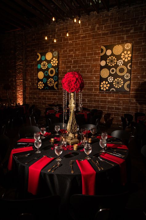 Great Gatsby Inspired Indoor Wedding Reception Decor Centerpiece at St. Pete Venue, Round Table with Black Satin Linens, Red Napkins, Red Roses Bouquets on Gold Vintage Pedestals with Hanging Crystals | Downtown St. Pete Wedding Venue NOVA 535 Wedding Decorations Red, Red Gold Wedding, Black Red Wedding, Black Wedding Decorations, Red Quince, Red Wedding Decorations, Indoor Wedding Receptions, Red Wedding Theme, Quince Decorations