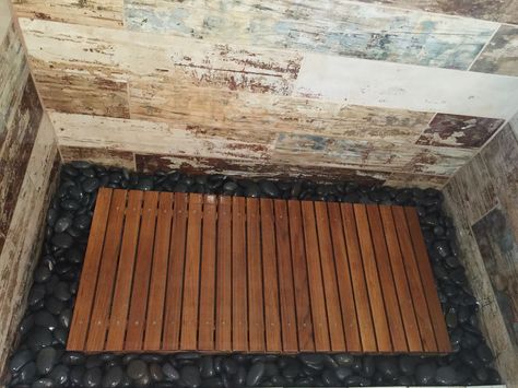 Teak wood shower floor surrounded by river rock, walls tiles in ceramic bar wood tile. Designed by Krysten Petersen of WTBH, LLC St. Pete, Florida Shower Stones Floor, Outdoor Shower Floor Ideas, Wood Shower Floor, Teak Shower Floor, Teak Shower Mat, Wood Tile Flooring, Rock Shower, Teak Bath, Shower Floor Mat