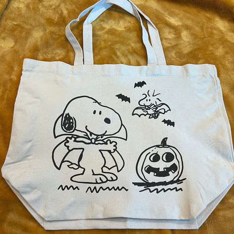 "Spooky Snoopy Halloween! This is a 19.7\"x15.7\"x7.9\" cotton canvas tote bag. This is made with HTV and a heat press. Hand wash gently inside out with cold water or spot clean. Lay flat to dry. Do not iron on the image. I make these all by hand to order so please expect a little variety in each tote :)" Spooky Snoopy, Snoopy Bag, Fall Tote Bag, Snoopy Halloween, Halloween Tote Bag, Halloween Tote, Snoopy Love, Fall Halloween Decor, Pretty Bags