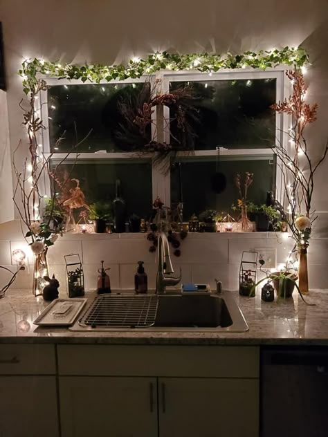 Vine and fairy lights over kitchen window Vine Lights Living Room, Fairy Light Home Decor, Vines In Kitchen Aesthetic, Fairy Lights Studio Apartment, Fairy Lights Kitchen Window, Fake Window Decor Living Room, Fairy Light Apartment, Fairy Light Bathroom Ideas, Kitchen With Fairy Lights