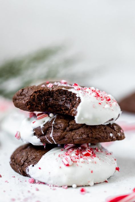 These Chocolate Peppermint Cookies are full of peppermint flavor, dipped in white chocolate and garnished with crushed candy canes! #peppermintcookies #christmascookies #chocolatepeppermint #peppermint #cookierecipe #christmasdesserts White Chocolate Dipped Peppermint Cookie, Peppermint Dipped Cookies, Peppermint Twist Cookies, Chocolate Crinkle Peppermint Cookies, Peppermint Hot Chocolate Cookies, Chocolate Peppermint Desserts, Christmas Peppermint Cookies, Peppermint Candy Cookies, Pepermint Cookies