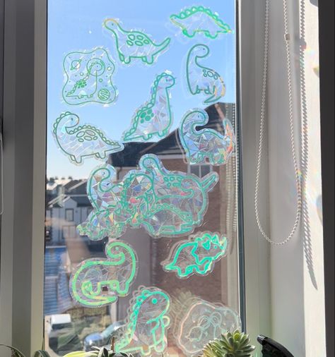 Adorable dinosaur window decals that create rainbows across your walls when hit with direct sunlight 🌈 Rainbow Window Sticker, Goblin Decor, Uni House, Rainbow Window, Pinterest Contest, Suncatcher Window, Hologram Stickers, Silly Things, Character Home