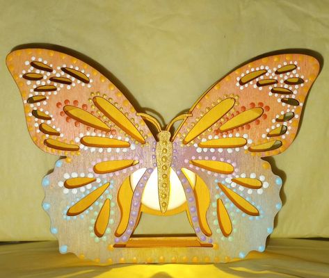 This is a light weight wooden butterfly nightlight . 

This is really gorgeous when it is on and the reflection of the light makes a great design on the wall. This is all hand painted and I decorated it with  light pastel color's . If you check out my Etsy account I do have more picture's available on this item. Wooden Butterfly Crafts, Wood Burning Butterfly, Painted Wooden Butterflies, Painted Wooden Butterfly, Mdf Butterfly Painting, Butterfly Wood Sign, Wooden Butterfly, Wood Butterfly, Butterfly Lighting