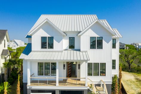 This white home is right on the coast of Daniel Island and Charleston, SC. It's interior and extorior both display a modern look. It is also covered by a dove grey metal roof. White House With White Roof, Beach House Metal Roof, White House White Roof, White House With Metal Roof, White House Gray Roof, White House Metal Roof, Light Metal Roof, White Roof House, Light Gray Roof