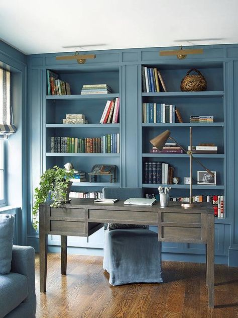 This home office room enjoys blue palette amongst a neutral foundation of natural wood grain flooring. Painted Bookshelf, Blue Home Offices, Transitional Home Office, Home Library Decor, Home Office Library, Blue Office, Home Library Design, Studio Living, Home Libraries