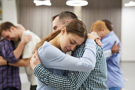 Empathy Exercise in Therapy Session by seventyfourimages. Waist up portrait of people hugging during group therapy session, focus on smiling young woman in foreground #Sponsored #Waist, #seventyfourimages, #people, #portrait Hugging Side View, Side View Portrait, Mixed Race Woman, People Hugging, Motivation Theory, Expressions Of Sympathy, Alcohol Use Disorder, Family Counseling, Black Salt