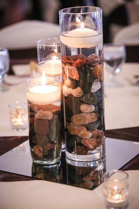 Vases With Rocks Centerpiece Ideas, River Rock Decorating Ideas, Rocks And Candles Centerpiece, River Rock Wedding Decor, Rocks Wedding Decor, Rock Wedding Centerpieces, Stone Wedding Centerpieces, River Rock Centerpiece, Wedding By The River Ideas