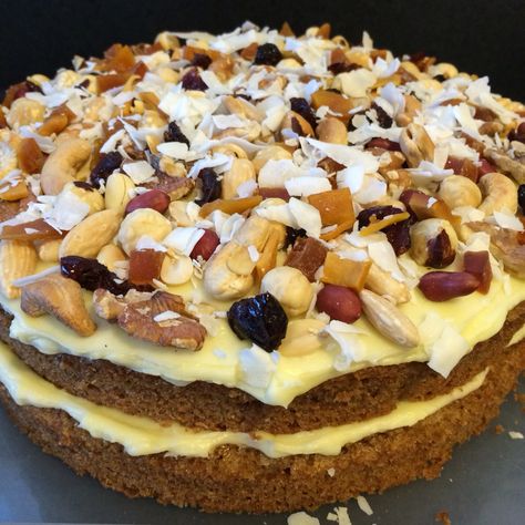 Carrot cake with layers of cream cheese frosting, decorated with nuts, dried  fruit and coconut shavings Dry Fruits Cake Decoration, Dry Fruits Cake, Cake With Layers, Fruits Cake, Fruit Birthday Cake, Grandad Birthday, Coconut Shavings, Fruit Birthday, Dry Fruit