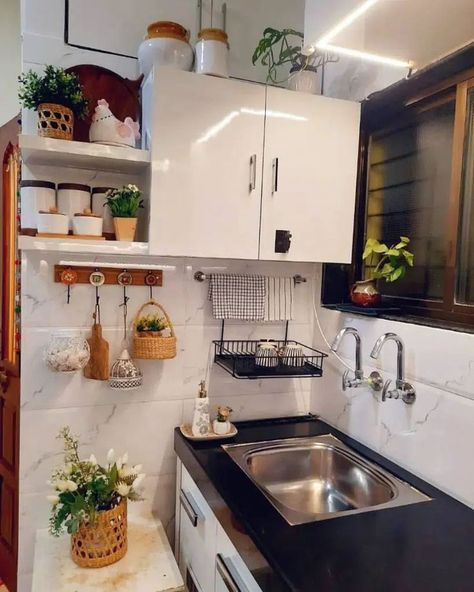 This kitchen also features a convenient solution for air-drying dishes. However, the drying rack is mounted to the wall instead of over the sink. Image credit: INSTAGRAM @HOMEVISIONTOREALITY Above The Kitchen Sink, Sink Organization, Above The Sink, Small Kitchens, Over The Sink, Drying Rack, Daily Activities, Kitchen Sink, The Kitchen