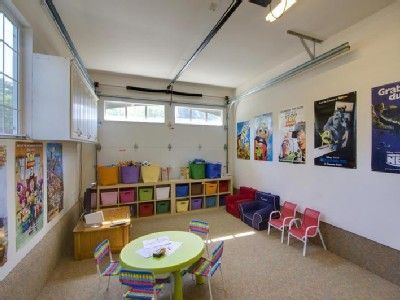 Garage has been converted to a playroom with TV, Wii, mini air hockey, arcade table, and more! 1912 House, Garage Classroom, Kids Garage, Opening A Daycare, Garage Playroom, Daycare Spaces, Homeschool Space, Arcade Table, Garage Transformation