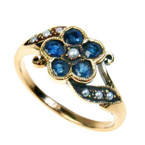 This pretty flower ring has been crafted in solid gold with reference to a Vintage floral design. Take a closer look to see the filigree scrolls which taper above each shoulder creating a feminine touch. With a combination of all NATURAL Gemstones of your choice, this ladies ring will be a daily reminder of natures beauty and an heirloom piece to be treasured foreverThe centre of the flower (see photo above) has a claw set Seed Pearl with bezel set Sapphires for the petals and 6x channel set Pea Garnet Ring Vintage, Vintage Sapphire Ring, Gold Flower Ring, Vintage Sapphire, Floral Ring, Gold Flower, Garnet Rings, Multi Stone Ring, Flower Ring