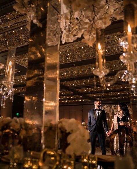 Stunning South Asian / Indian wedding. Glimmering gold black tie with orchids. + Vendors:  Bride: @missrocky08 Photo: @Andrewkwakphoto  Venue: @hyattregencylongbeach Video: @onetake_timmy Makeup:@dolledupbylulu Planner:@bel_events Mendhi: @desairachna Designer: @miss.kismet Black And Gold Wedding Aesthetic, Black Indian Wedding, Black Gold Wedding Theme, Gold Indian Wedding, Asian Wedding Venues, Indian Wedding Aesthetic, Big Indian Wedding, Indian Wedding Venue, Reception Pictures