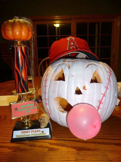 Baseball Pumpkin: 1. Carve face into pumpkin. 2. Spray paint white 3. Draw or paint baseball lines around the sides 4. For the bubble gum, Attach pink balloon to mouth with tape or glue 5. Add you favorite team's hat And there you go! Baseball pumpkin! Baseball Theme Trunk Or Treat, Softball Costumes, Rv Halloween, Angles Baseball, Baseball Pumpkin, Unique Pumpkin Decorating, Halloween Softball, Baseball Centerpiece, Baseball Halloween