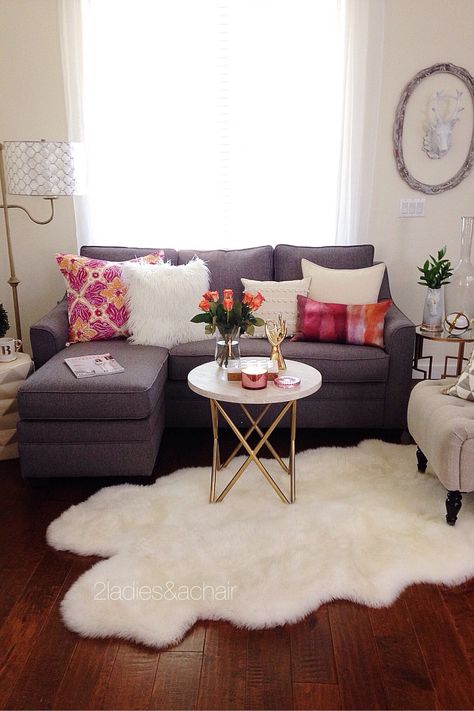 In this room the pop of bright color from 2 pillows is accentuated by the grey and white colors surrounding them. White is a bright color too. In this case it is positioned on every surface in this room. The white coffee table (from HomeGoods) helps visually in making this vignette feel complete and anchors the space. Sponsored by HomeGoods Furnitur Ruang Keluarga, First Apartment Decorating, Decor Ikea, Small Apartment Living Room, Casa Vintage, Small Living Room Decor, Room Apartment, Small Apartment Decorating, Small Apartment Living