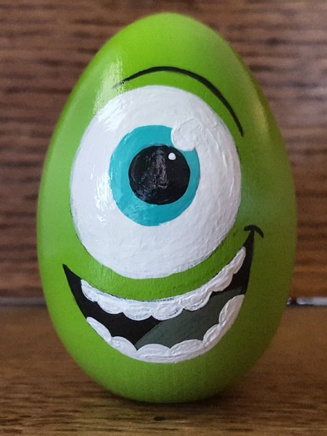 Monsters Inc Painted Rocks, Egg Painting Ideas Easy, Easter Egg Designs Creative, Mike Wazowski Rock Painting, Easter Egg Rock Painting Ideas, Easy Egg Painting Ideas, Monster Rock Painting, Egg Rock Painting, Cute Easter Egg Designs