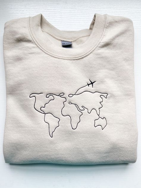 Embroidery, travel embroidery, tan sweatshirt, tan, crew, embroidery machine, world map World Map Embroidery, Embroidery Shoes Diy, Travel Embroidery, Embroidery Hoop Art Tutorial, Map Embroidery, Embroidery Map, Denim Pocket Details, Tshirt Printing Business, Hang Tags Clothing