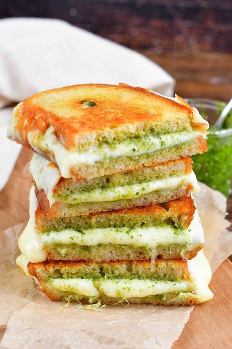 Pesto Grilled Cheese is the ultimate easy sandwich for pesto lovers! Gooey mozzarella and provolone cheeses are complimented by vibrant basil pesto between two buttery slices of warm bread. Mozzarella And Pesto Sandwich, Grilled Cheese And Pesto Sandwich, Grilled Cheese With Pesto, Basil Pesto Grilled Cheese, Mozzarella Sandwich Recipes, Basil Pesto Sandwich, Pesto Mozzarella Sandwich, Pesto Cheese Sandwich, Pineapple Cheeseball Recipes