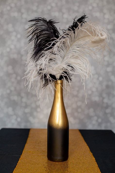 These DIY Gatsby party centerpieces are awesome! I love the ones made with ostrich feathers and the champagne glass tower. A perfect addition to my roaring 20s party decor. #entertainingdiva #roaring20s #gatsbywedding #centerpieces #partydecor #diypartydecor Art Deco Wedding Centerpieces Diy, Roaring 20s Centerpieces Diy, 1920s Holiday Party, 20s Decorations 1920s Party, 1920s Centerpieces Roaring 20s, Diy Gatsby Party, Gatsby Centerpiece Ideas, Great Gatsby Centerpiece, Great Gatsby Centerpieces