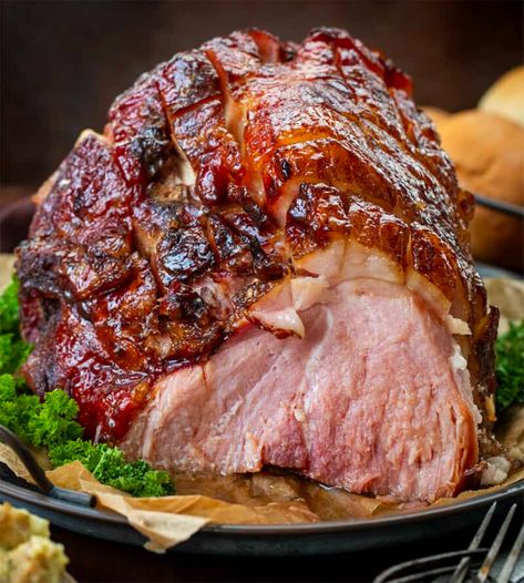 Brown Sugar Glazed Ham is a bone-in ham topped and roasted with a sweet, tangy, and spiced brown sugar glaze that creates a caramelized coating. It is so easy to make and perfect for your Christmas dinner menu! It is so delicious in all of your leftover ham recipes! Christmas Ham Bone In, Bone In Ham Recipes Crock Pots, Bone In Ham Oven, Bake A Ham In The Oven, Bone In Ham, Brown Sugar Glazed Ham, Ham Shank, Christmas Ham Recipes, Thanksgiving Ham