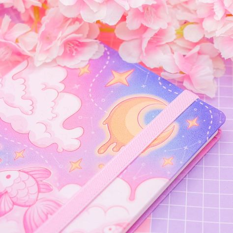 ✨ Cosmic Swim hardcover journals are BACK! ✨ Thank you for all the love for these!! 💕 - #journal #notebook #pink #pinkaesthetic #art #aesthetic #artist #kawaiiaesthetic #kawaiiart #kawaii #journalinspiration #plannercommunity #planner #pastelpink #pastelart #cuteart #stationery #stationerylove #stationeryaddict #digitaldrawing #digitalartist #digitalart #originalart #moon #space #dreamy #nautical #bujo #bulletjournal Pink Bookmark, Bookmark Ribbon, Cute Notebooks, Notebook Stickers, Dot Grid, Notebook Journal, Bullet Journals, Pastel Art, Kawaii Art