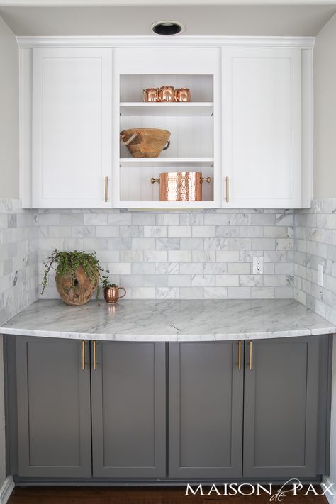 Two-toned gray and white cabinets, marble subway tile, Carrara countertops, a big farmhouse sink, and brass hardware give this kitchen a classic yet modern look. Modern Farmhouse Kitchen Cabinets, White Marble Kitchen, Серая Кухня, Kitchen Ikea, Gray And White Kitchen, Kabinet Dapur, Farmhouse Kitchen Cabinets, New Kitchen Cabinets, Kitchen Cabinets Makeover