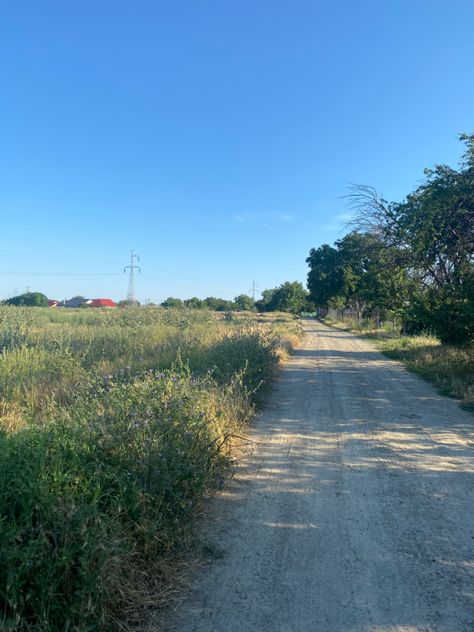 Image of a road in a small village area, surrounded by trees, bushes, flowers. The sky is clear and the sun is shining, suggesting a nice and warm temperature. Village Aesthetic, European Town, European Summer Aesthetic, European Village, Europe Holidays, Europe Aesthetic, European Aesthetic, Small Town Life, Small Town Romance