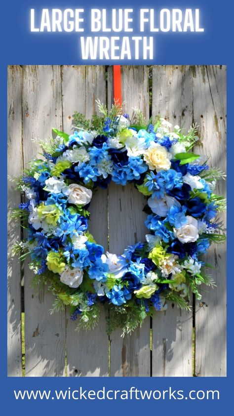 A large beautiful floral wreath for front door and indoor decorating. Foam hoop wreath form is 18 inches and loaded with lots of roses, hyacinth, lilacs, daisies, lilies and hydrangea in dark blues, light blues and white. Finished item measures 24 inches. A lovely, year-round front door and indoor decoration. Wreaths make lovely gifts for any occasion. #blueflowers #flowers #wreath #handmadewreath Blue Floral Wreath, Wicked Crafts, St Patricks Decorations, Felt Flower Wreaths, Beautiful Front Doors, Orange Wreath, Wreaths For Sale, White Wreath, Wreath Maker