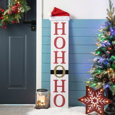 Crafted from textured MDF, this Christmas sign features a lambswool hat on the top of the sign. On one side is a smiling snowman with a Welcome printed on its body. The other side is the Santa belt with HoHoHo. Stylish design with classical red and black, it brings a traditional and classic feel to your holiday home. | The Holiday Aisle® Junno Reversible Wooden Christmas Snowman Porch Sign 42.5 H x 8.25 W x 2.25 D in black / brown / red / whiteWood in Black / Red | 42.5" H X 8.25" W X 2.25" D | Christmas Signs Wood Front Porches, Santa Belt, Christmas Wooden Signs, Wooden Porch, Wooden Welcome Signs, Front Porch Signs, Porch Welcome Sign, Christmas Signs Wood, Holiday Signs