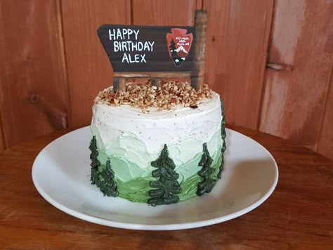 National Park Service wooden sign birthday cake with mountains and trees. Mountain Smash Cake, National Park Cake Ideas, National Parks Cake, Mountain 1st Birthday, Camping First Birthday Cake, National Park Cupcakes, National Park Birthday Cake, Camping Themed Birthday Cake, Nature Cakes Birthday